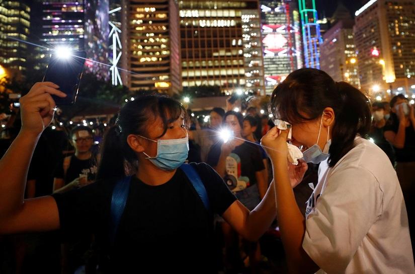Protesters cry during a silent moment as students attend a rally to call for political reforms outside City Hall in Hong Kong, China, August 22, 2019. REUTERS