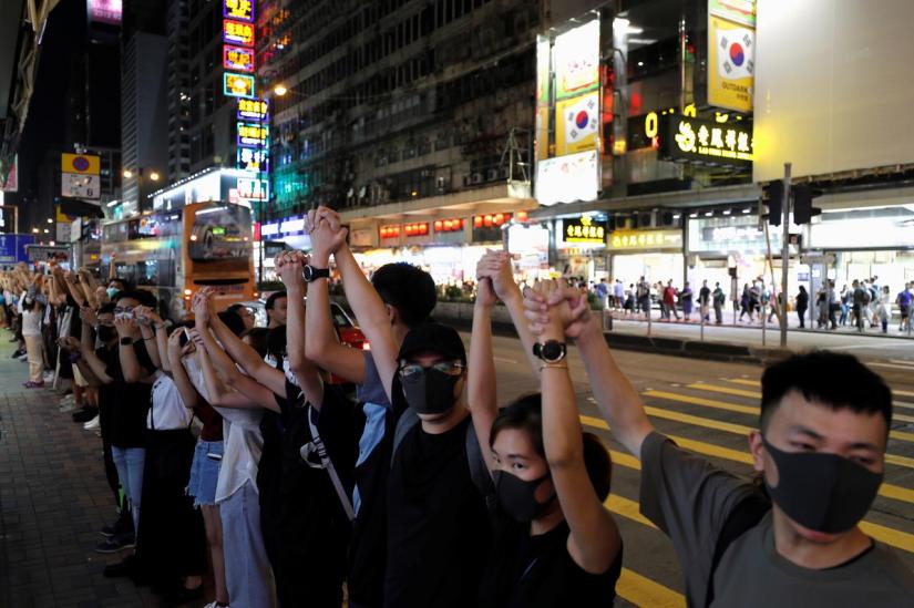 Anti-extradition bill protesters hold hands to form a human chain during a rally to call for political reforms at Mongkok, in Hong Kong, China, Aug 23, 2019. REUTERS