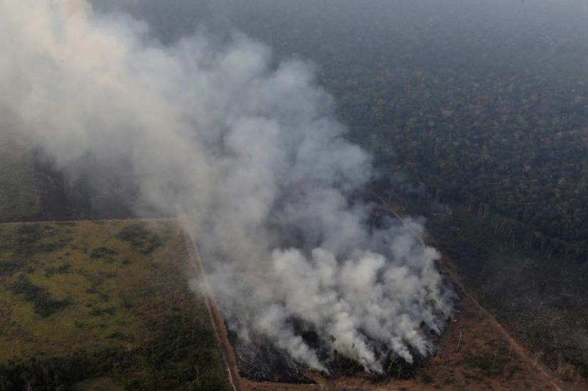 Smoke billows during a fire in an area of the Amazon rainforest near Porto Velho, Rondonia State, Brazil, Brazil August 21, 2019. REUTERS