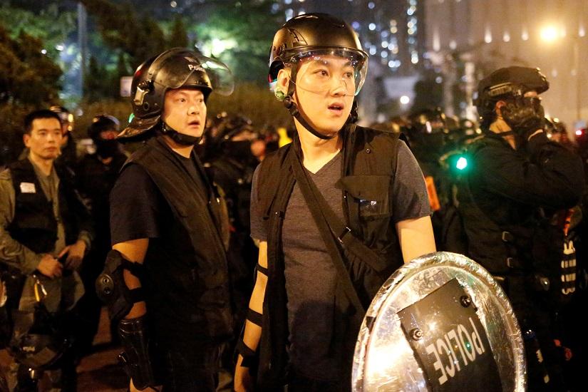 Police and riot police pause during a march to clear off protesters and residents in Wong Tai Sin in Hong Kong, China, Aug 24, 2019. REUTERS