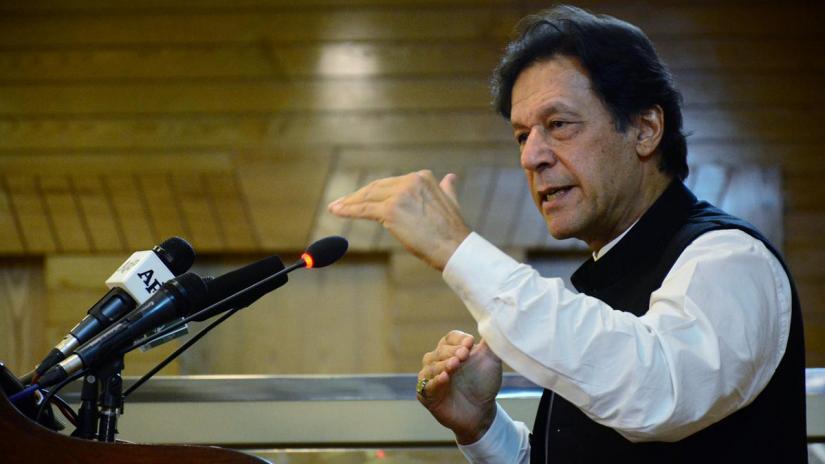 FILE PHOTO: Pakistani Prime Minister Imran Khan gestures as he addresses the Azad Kashmir parliament on Pakistan`s 72nd Independence Day in Muzaffarabad, Pakistan-administered Kashmir, Aug 14, 2019. REUTERS