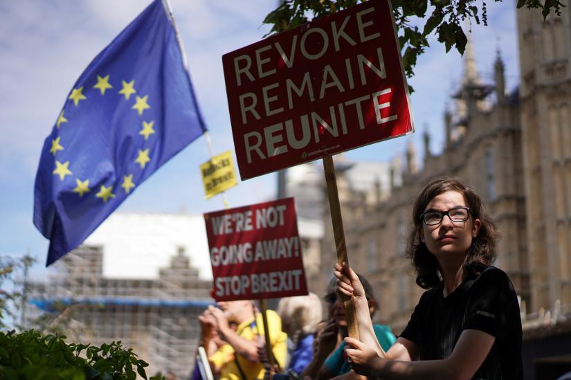 An anti-Brexit protestor holds a sign outside the Houses of the Parliament in London, Britain August 28, 2019. REUTERS