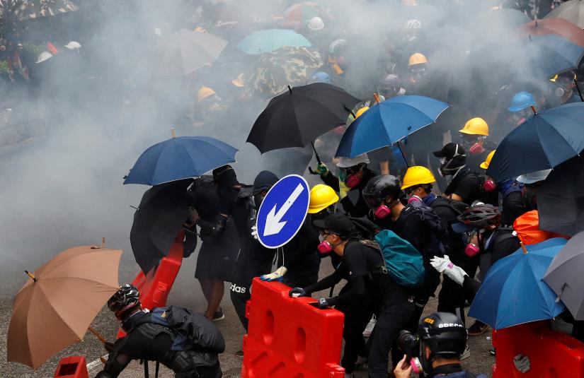 Demonstrators react after police fired tear gas during a protest in Hong Kong, China August 31, 2019. REUTERS