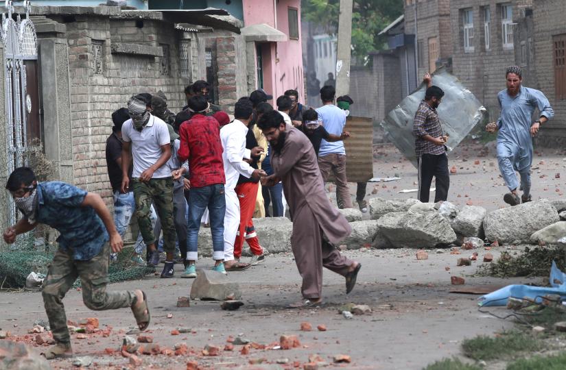 Kashmiris take cover as Indian security forces (unseen) fire teargas shells during clashes, after scrapping of the special constitutional status for Kashmir by the Indian government, in Srinagar, August 30, 2019. REUTERS