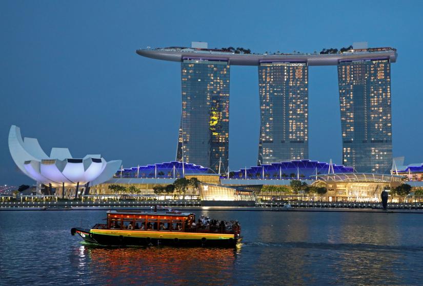 FILE PHOTO: A tourist bum boat passes by the Marina Bay Sands hotel in Singapore July 3, 2019. REUTERS