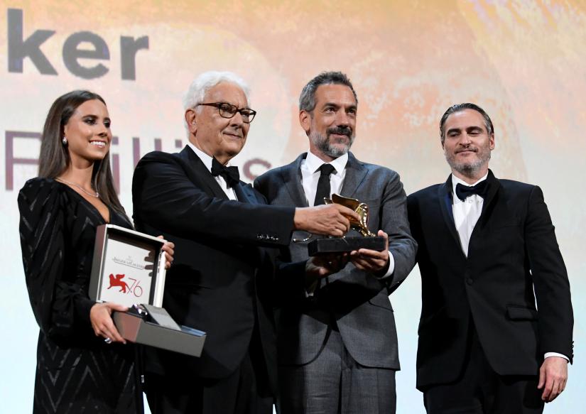 The 76th Venice Film Festival - Awards Ceremony - Venice, Italy, September 7, 2019 - Director Todd Phillips poses next to actor Joaquin Phoenix and Venice Biennale President Paolo Baratta after winning the Golden Lion for Best Film. REUTERS