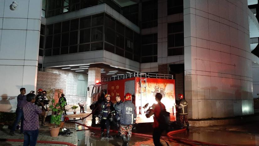 Firefighters are seen trying to douse a fire that breaks out at the ground floor of Election Commission office in Dhaka`s Agargaon on Sunday (Sept 8).