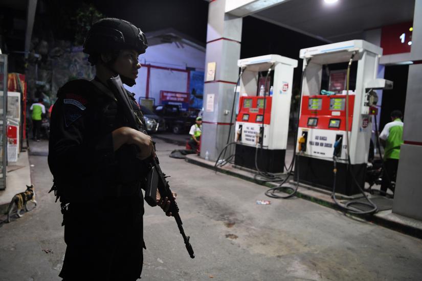 Police Mobile Brigade (Brimob) officer stands guard at a gas station in Jayapura, Papua, August 31, 2019 in this photo taken by Antara Foto via REUTERS