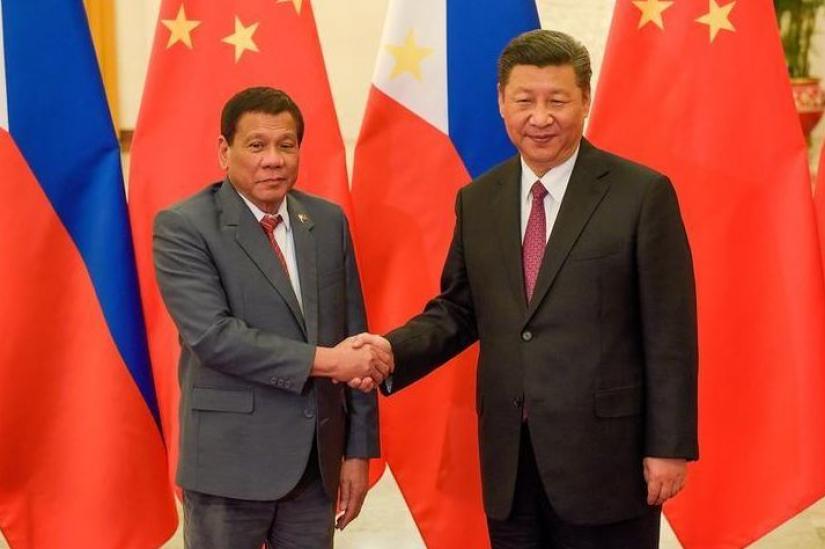 Chinese President Xi Jinping shakes hands with Philippines President Rodrigo Duterte in Beijing. REUTERS