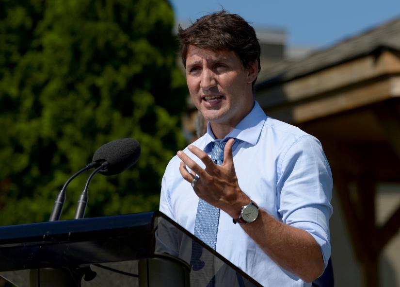 FILE PHOTO: Canada`s Prime Minister Justin Trudeau speaks about a watchdog`s report that he breached ethics rules by trying to influence a corporate legal case, at the Niagara-on-the Lake Community Centre in Niagara-on-the-Lake, Ontario, Canada, August 14, 2019. REUTERS