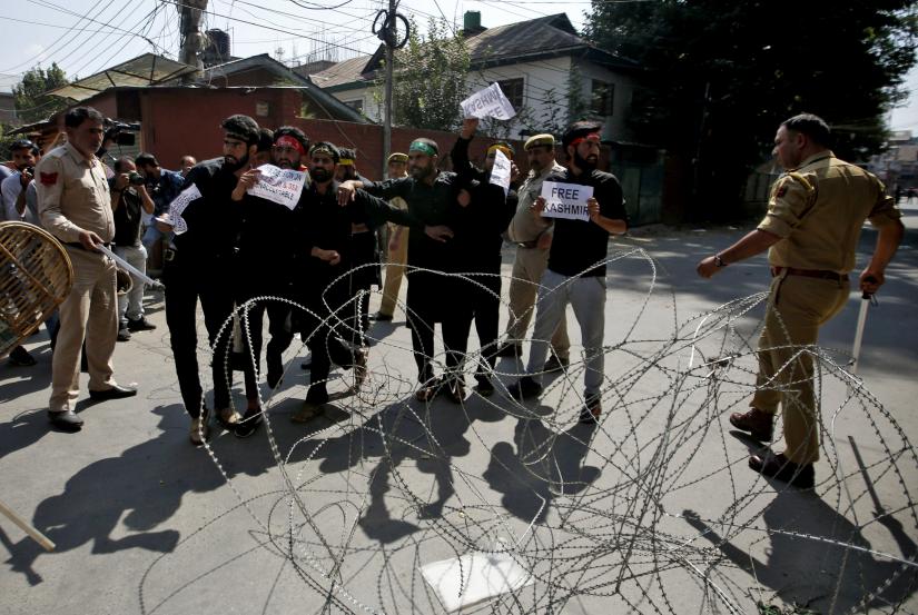 Kashmiri Shi`ite Muslims shout slogans behind concertina wire as they are stopped by Indian police while trying to participate in a Muharram procession, during restrictions following the scrapping of the special constitutional status for Kashmir by the Indian government, in Srinagar, September 8, 2019. REUTERS