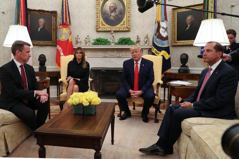 US President Donald Trump speaks about banning non-tobacco flavored vaping products next to first lady Melania Trump as Health and Human Services (HHS) Secretary Alex Azar (R) and Acting Food and Drug Administration (FDA) Administrator Norman Sharpless listen in the Oval Office of the White House in Washington, U.S., September 11, 2019. REUTERS