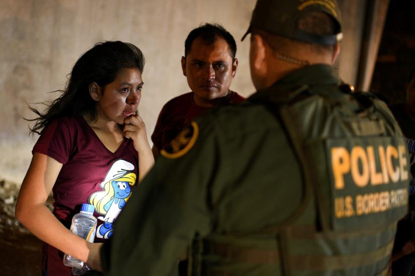 Thirteen year-old Joseline, a Guatemalan migrant seeking asylum with father Jose Luis, cries after crossing the Rio Grande and turning herself in to U.S. Border Patrol in Hidalgo, Texas, U.S., August 23, 2019. Picture taken August 23, 2019. REUTERS