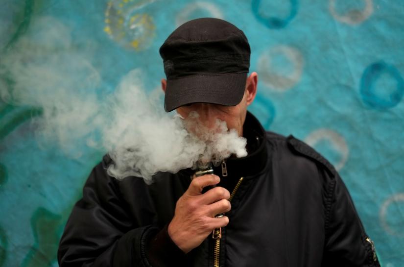 A man poses for a picture, as he vapes at home in La Paz, Bolivia, February 2, 2019. REUTERS