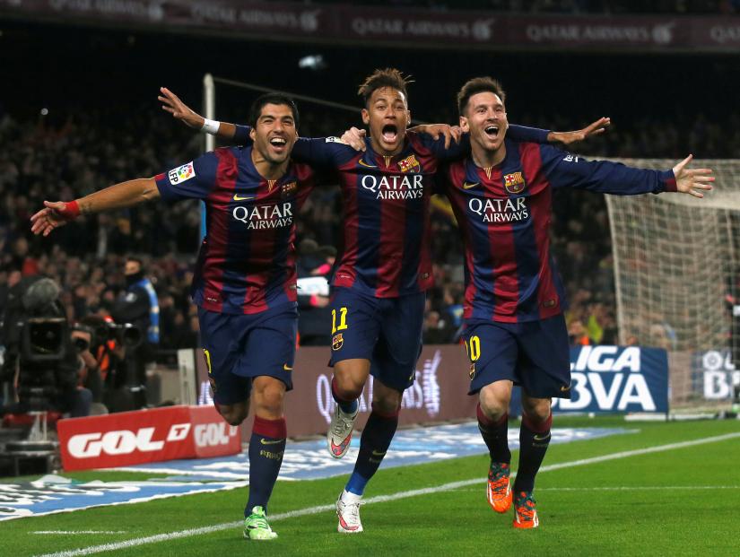 Barcelona`s Luis Suarez, Neymar and Lionel Messi celebrate a goal against Atletico Madrid during their Spanish First Division soccer match at Camp Nou stadium in Barcelona January 11, 2015. REUTERS