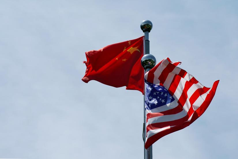 Chinese and U.S. flags flutter near The Bund, before U.S. trade delegation meet their Chinese counterparts for talks in Shanghai, China July 30, 2019. REUTERS/File Photo