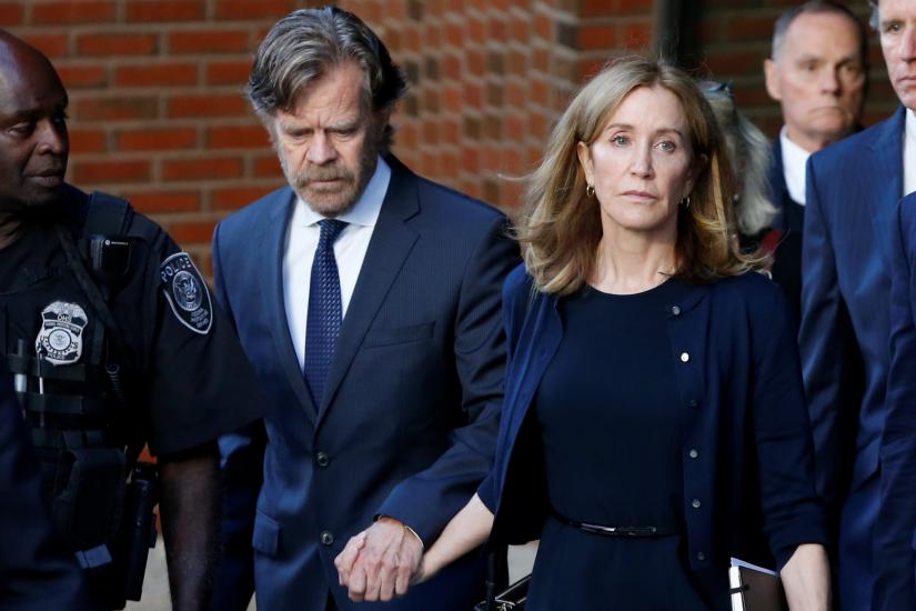 Actress Felicity Huffman leaves the federal courthouse with her husband William H. Macy, after being sentenced in connection with a nationwide college admissions cheating scheme in Boston, Massachusetts, US, September 13, 2019. REUTERS