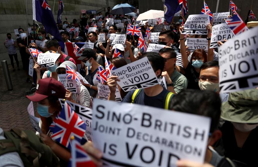 Anti-government protesters hold up banners, placards, Union Jack flags as they gather at the British consulate General in Hong Kong, China, September 15, 2019. REUTERS