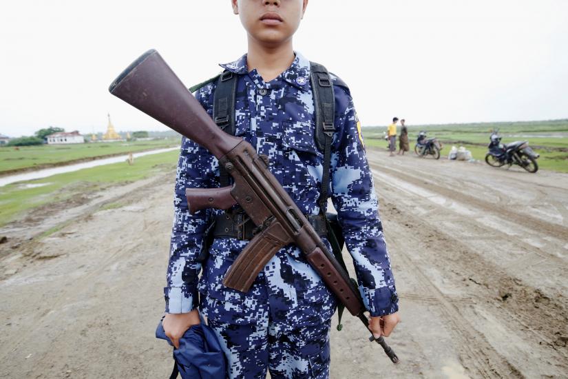 Myanmar police officer poses for a photograph in Maungdaw, Rakhine July 9, 2019. Picture taken on July 9, 2019. REUTERS