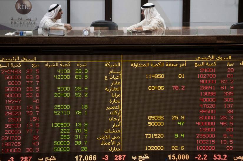 Kuwaiti traders are seen at the Kuwait Boursa stock market trading hall in Kuwait city, Kuwait September 16, 2019. REUTERS