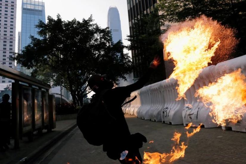 An anti-government protester throws a Molotov cocktail during a demonstration near Central Government Complex in Hong Kong, China Sept 15, 2019. REUTERS