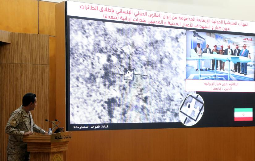 Official spokesperson for the Saudi-led coalition fighting in Yemen, Colonel Turki Al-Malik displays on a screen a satellite image shows an drone strike during a news conference, in Riyadh, Saudi Arabia September 16, 2019. REUTERS