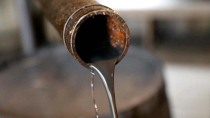 FILE PHOTO: Oil pours out of a spout from Edwin Drake`s original 1859 well that launched the modern petroleum industry at the Drake Well Museum and Park in Titusville, Pennsylvania US, Oct 5, 2017. REUTERS