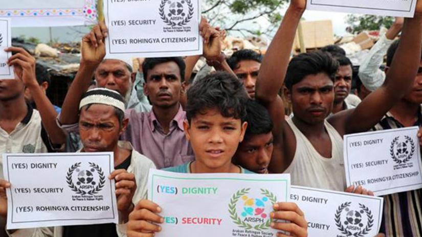 Rohingyas hold placards prior to the arrival of UN secretary general Antonio Guterres and World Bank president Jim Yong Kim at the Kutupalong refugee camp in Cox’s Bazar, Bangladesh, July 2, 2018. REUTERS