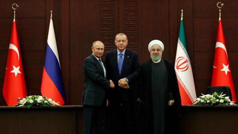 Presidents Vladimir Putin of Russia, Tayyip Erdogan of Turkey and Hassan Rouhani of Iran pose following a joint news conference in Ankara, Turkey, Sept 16, 2019. REUTERS