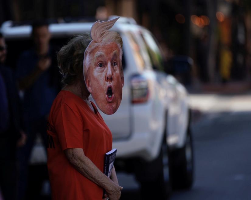 A protesters walks to a demonstration against U.S. President Donald Trumps fundraising luncheon in San Diego, California, U.S., September 18, 2019. REUTERS