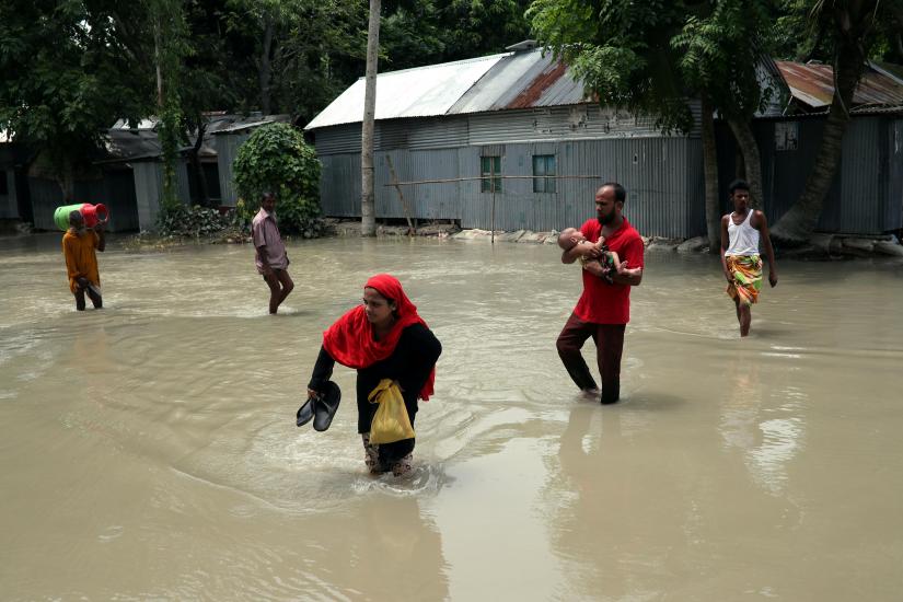 People cross a flooded road in Jamalpur, Bangladesh, July 22. REUTERS/File Photo