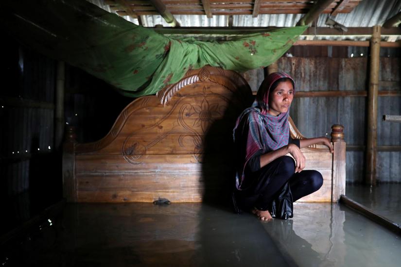 Shilpi, a flood-affected woman poses for a picture inside her flooded house in Jamalpur, Bangladesh, July 21. REUTERS/File Photo