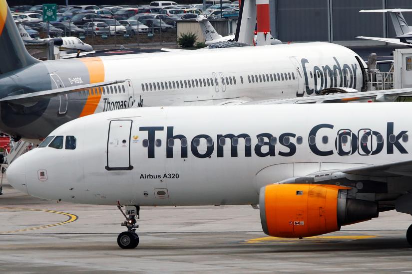 An Airbus A320 of Thomas Cook Airlines passes next to a Boeing 757-300 of Condor Airlines after landing at Duesseldorf Airport, Germany September 23, 2019. REUTERS