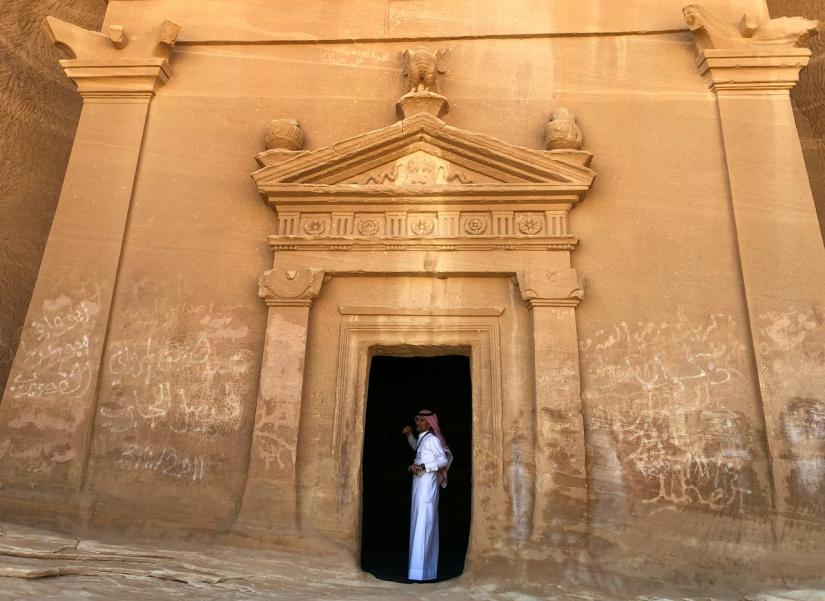 FILE PHOTO: A Saudi tour guide stands inside a tomb at Madain Saleh antiquities site, al-Ula, Saudi Arabia Feb 10, 2019. REUTERS