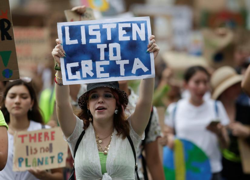 People hold placards during a Fridays for Future march calling for urgent measures to combat climate change, in Monterrey, Mexico, September 27, 2019. REUTERS