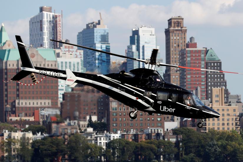 A helicopter operated by Uber Copter, a new service by the ride-sharing company Uber, providing service from Manhattan to New York`s JFK International Airport initially for Diamond and Platinum Uber Rewards members as well as special Uber partners takes off from Manhattan, New York, U.S., October 2, 2019. Picture taken October 2, 2019. REUTERS