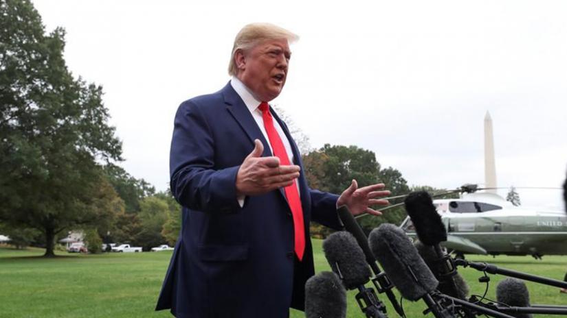 US President Donald Trump talks to reporters as he departs for travel to Florida from the South Lawn of the White House in Washington, US, Oct 3, 2019. REUTERS