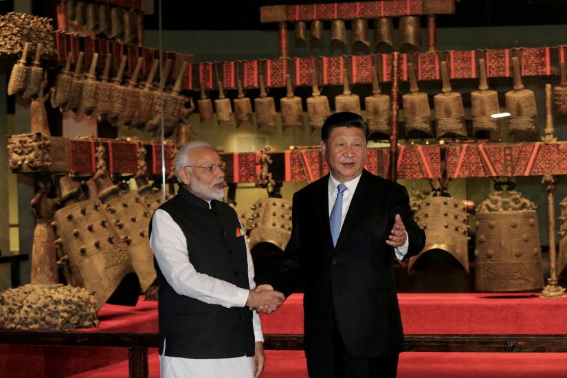 Chinese President Xi Jinping and Prime Minister Narendra Modi shake hands as they visit the Hubei Provincial Museum in Wuhan, Hubei province, China April 27, 2018. China Daily via REUTERS/File Photo