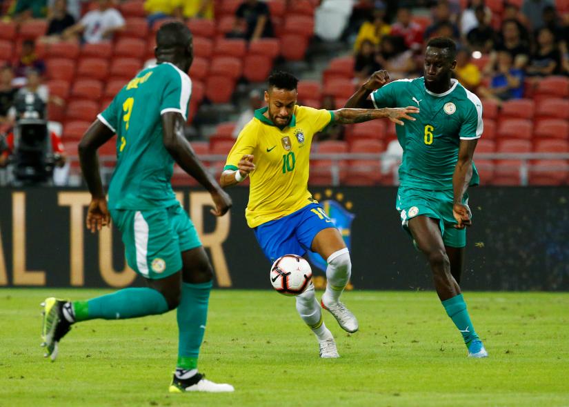 Brazil`s Neymar in action with Senegal`s Salif Sane REUTERS