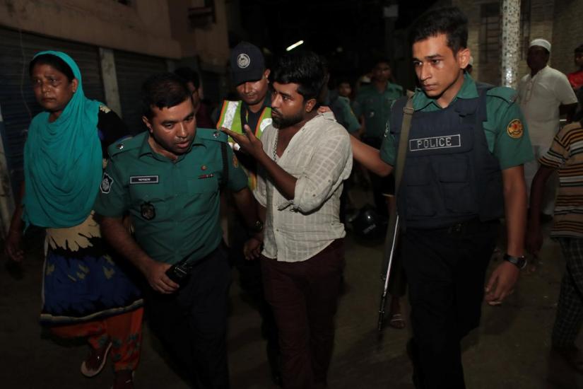 Police detain a man during an anti drug raid in Dhaka in August, 2018 REUTERS/File Photo