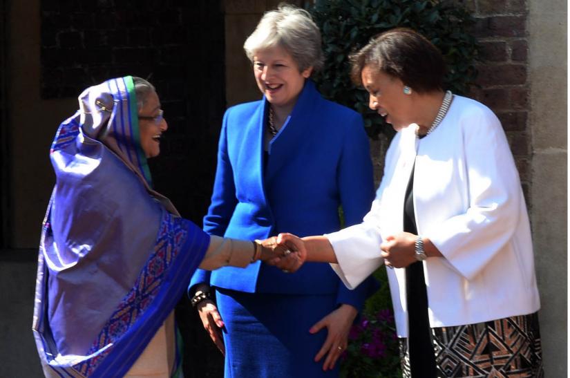 Prime Minister Sheikh Hasina shakes hands with Commonwealth Secretary General Patrica Scotland at Lancaster House in London on April 19, 2018 ahead of the inaugural function of CHOGM-2018 while then-British Prime Minister Theresa May looks on. PID/File Photo