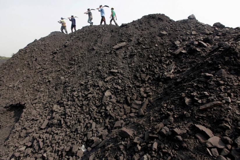 Workers walk on a heap of coal at a stockyard of an underground coal mine in coal fields in the eastern Indian state of Orissa, March 28, 2012. REUTERS/File Photo