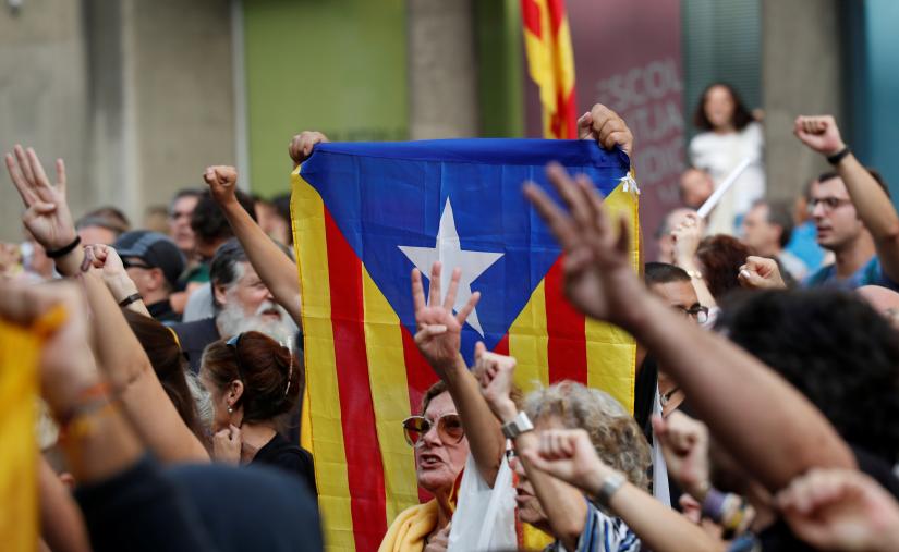 Supporters of Catalonia`s independence hold an Estelada (Catalan separatist flag) as they gesture during a protest against upcoming ruling of the Spanish Supreme Court against the independence movement`s leaders, in Barcelona, Spain, October 13, 2019. REUTERS