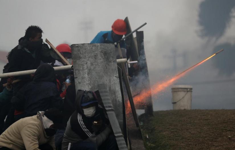 Demonstrators fire a homemade weapon during a protest against Ecuador`s President Lenin Moreno`s austerity measures, in Quito, Ecuador Oct 13, 2019. REUTERS