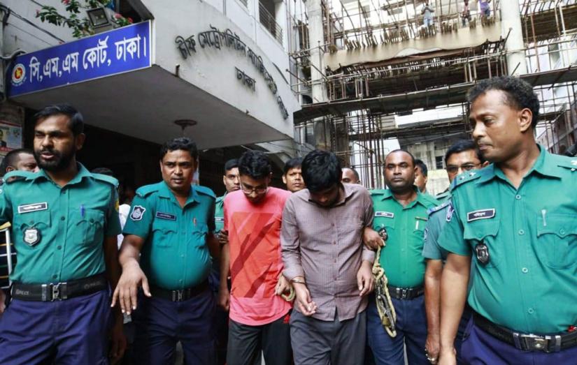 Police escort BUET murder suspects Hosssain Mohhammad Toha (right) and Amit Saha at the premises of the Chief Metropolitan Magistrate Court in Dhaka, Oct 11, 2019. FILE PHOTO/Mahmud Hossain Opu