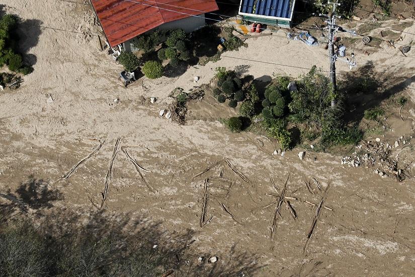 An aerial view shows the characters for `water and food` written on muddy ground at a flooded area caused by Typhoon Hagibis in Marumori Town, Miyagi prefecture, Japan, October 15, 2019, in this photo taken by Kyodo Mandatory credit Kyodo/via REUTERS