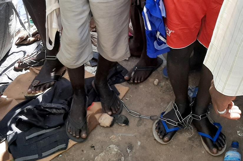 FILE PHOTO: People with chained legs are pictured after being rescued by police in Sabon Garin, in Daura local government area of Katsina state, Nigeria Oct 14, 2019. REUTERS