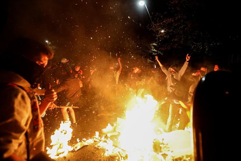 Demonstrators crowd around a makeshift bonfire during a protest after a verdict in a trial over a banned independence referendum in Barcelona, Spain, Oct 17, 2019. REUTERS