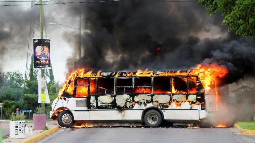 A burning bus, set alight by cartel gunmen to block a road, is pictured during clashes with federal forces following the detention of Ovidio Guzman, son of drug kingpin Joaquin `El Chapo` Guzman, in Culiacan, Sinaloa state, Mexico Oct 17, 2019. REUTERS