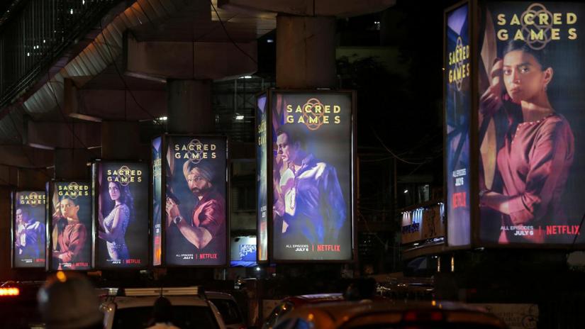 FILE PHOTO: Traffic moves on a road past hoardings of Netflix`s new television series `Sacred Games` in Mumbai, India, Jul 11, 2018. REUTERS